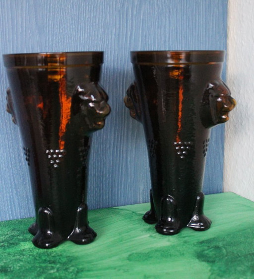 Antique wine tankard made of heavy amber glass with lion heads and paws