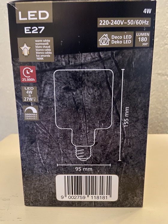 Image 1 of Bronze table lamp depicting a cherub playing the guitar