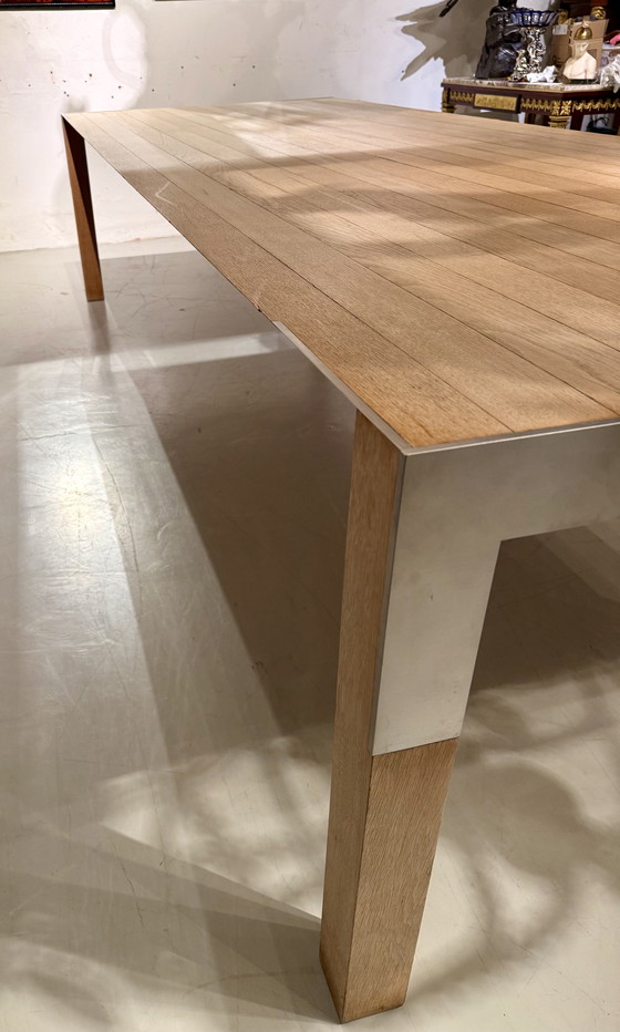 Image 1 of A large oak dining table, designed by Claire Bataille and Paul Ibens