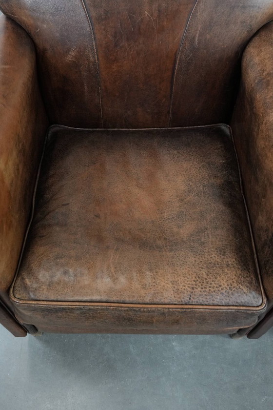 Image 1 of 2 x Vintage sheepskin armchair with warm colours and a characterful appearance