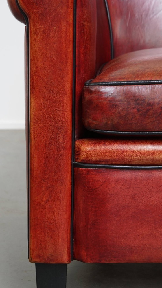 Image 1 of Fauteuil gemaakt van schapenleer in een rood/ bruine kleur