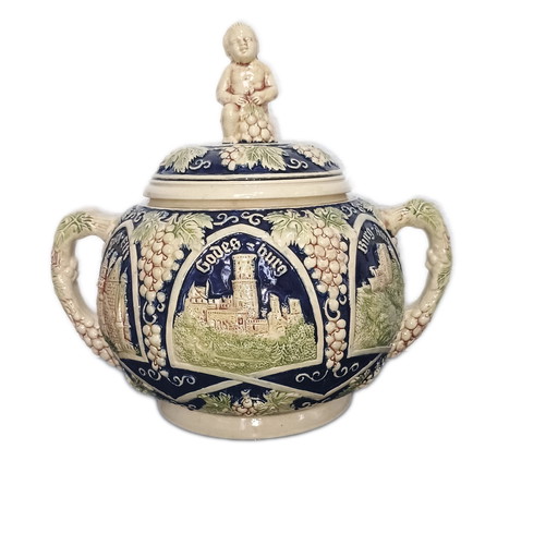 Old bowl with ladle. Castle motifs in relief.