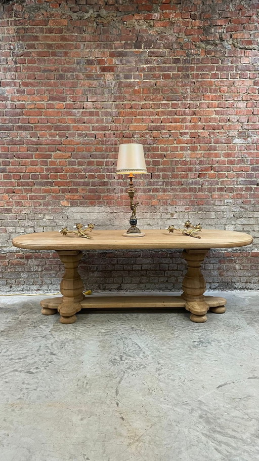 Solid oval monastery table of bleached oak with turned legs