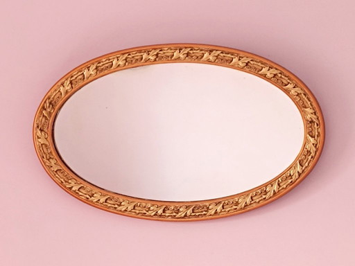Oval mirror with gold and ornate frame