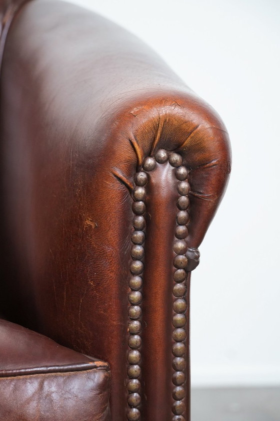 Image 1 of Vintage clubfauteuil gemaakt van schapenleer met siernagels