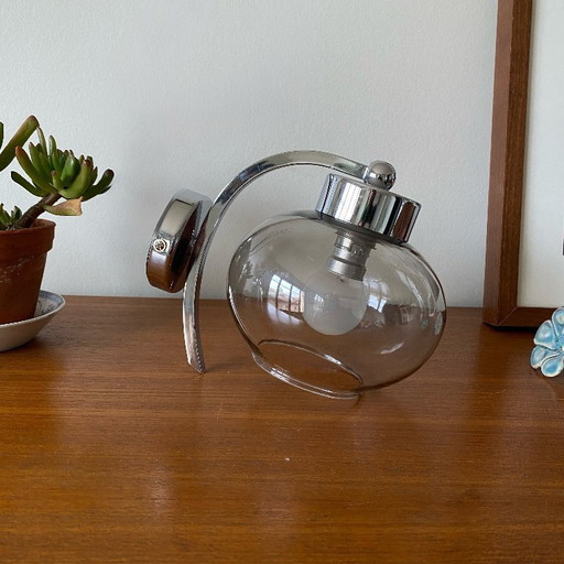 Wall light in chromed metal and smoked grey glass globe
