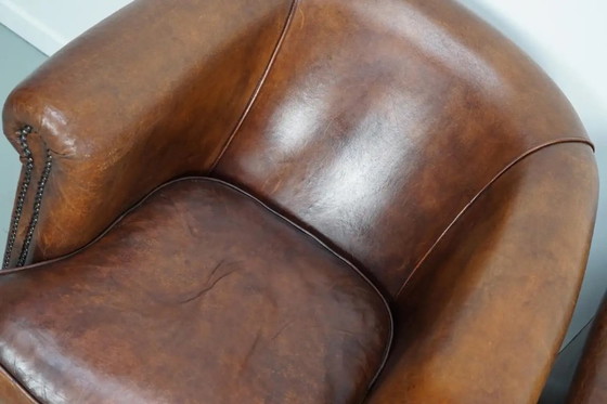 Image 1 of Vintage Nederlandse leren clubfauteuils in cognackleur, set van 2 met voetenbank