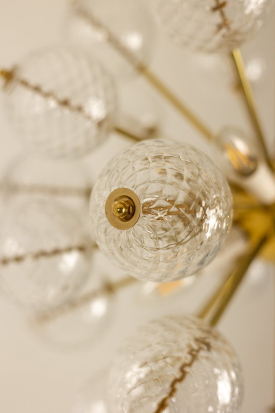 Image 1 of Kamenicky Senov, editor. Pair of brass and glass chandeliers. Circa 1970