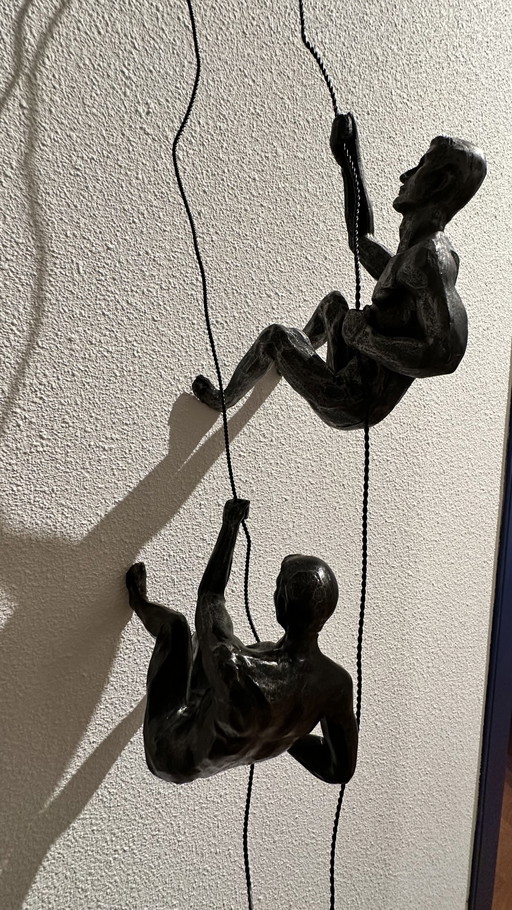 Climbing Man Hanging on Wire