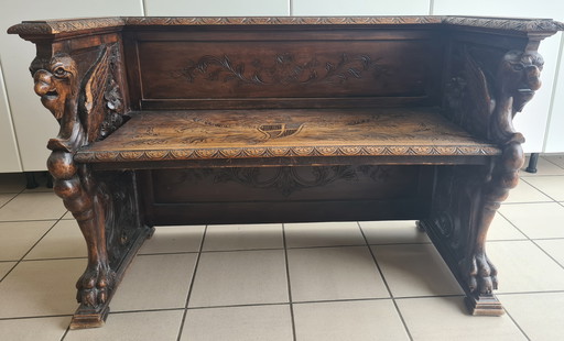 Wooden bench with hand-carved figures