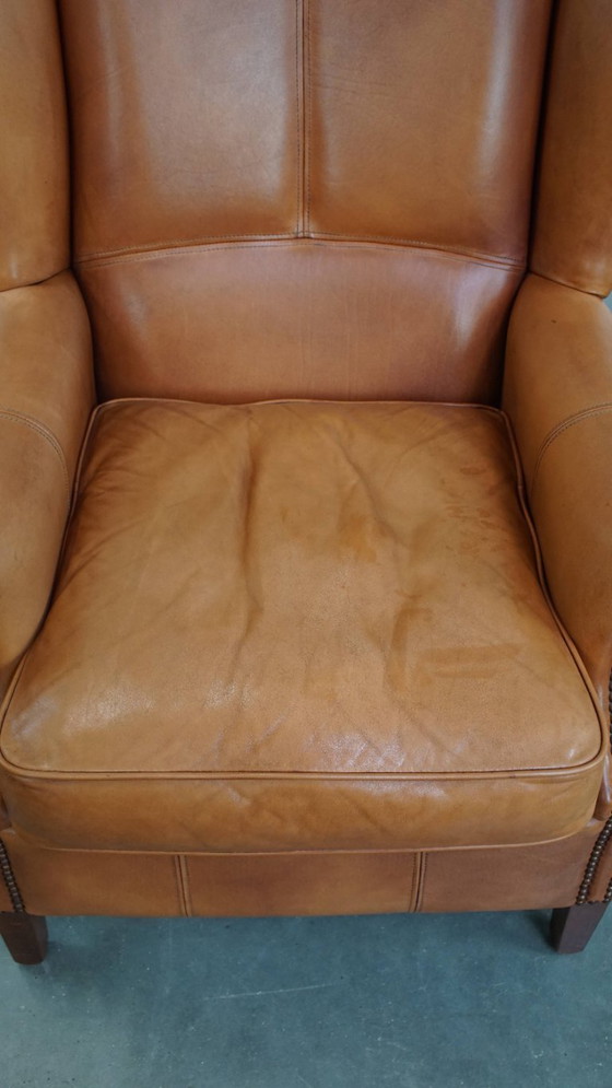 Image 1 of Oorfauteuil gemaakt van rundleer afgewerkt met siernagels