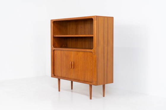 Image 1 of Bookcase in teak by Svend Dyrlund with tambour doors (Denmark, 1960s).