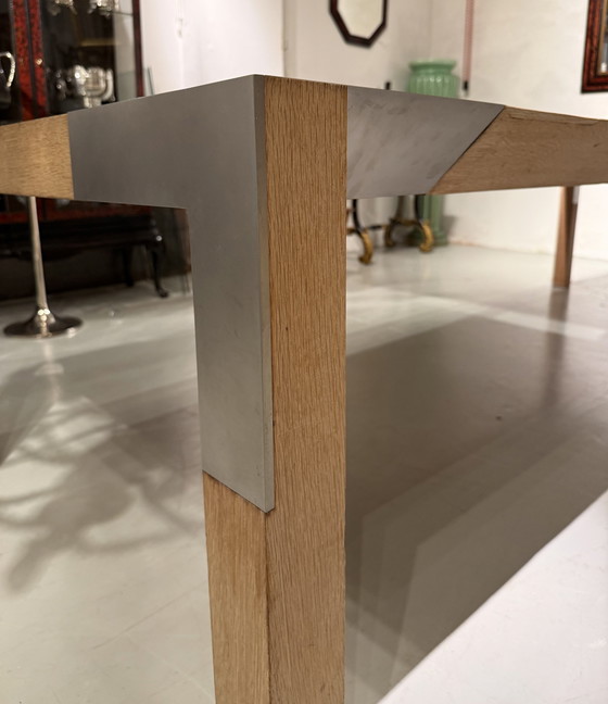 Image 1 of A large oak dining table, designed by Claire Bataille and Paul Ibens