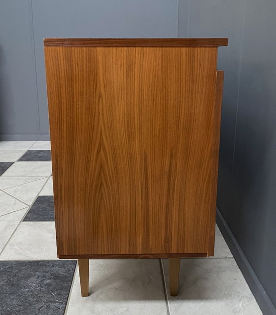 Image 1 of Dressoir uit de jaren 70 met decoratieve lijn boven de deuren.