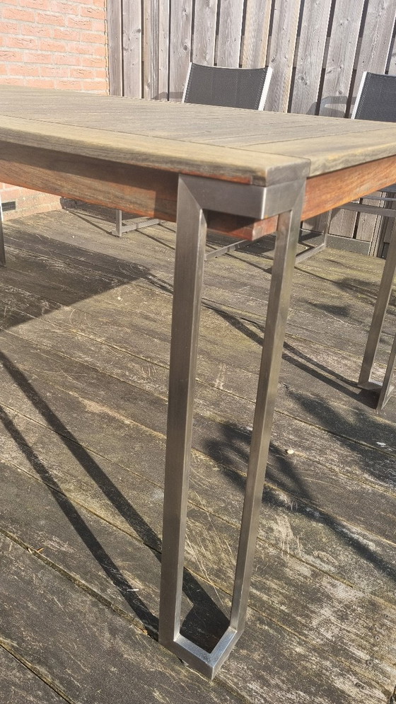 Image 1 of Set da giardino con tavolo in teak e 4 sedie in acciaio inox, realizzato in teak e textilene.