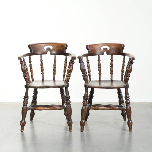 2x antique English wooden pub/captain chairs from the late 19th century with character and a beautiful color scheme