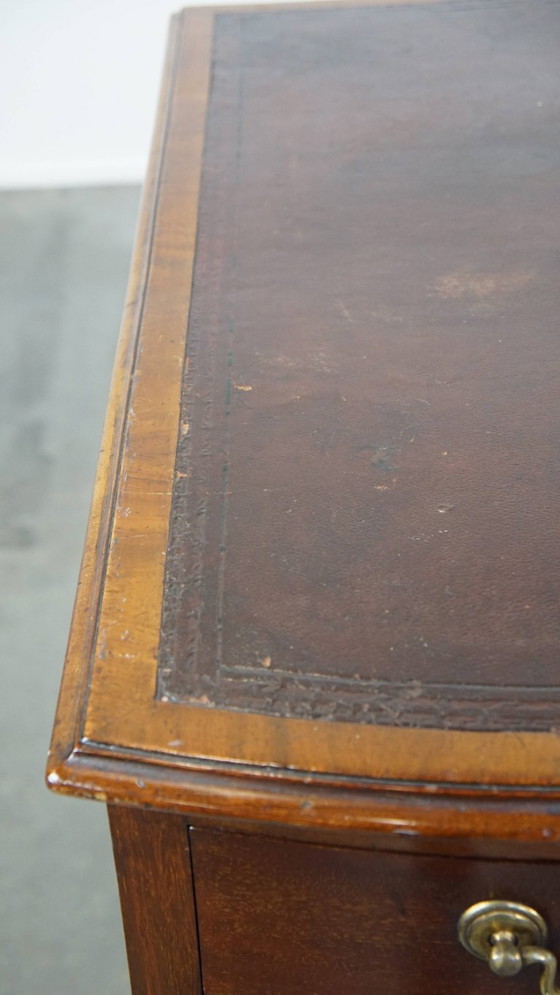 Image 1 of Luxurious and antique English wooden desk from the late 19th century with a leather top and a curved front.