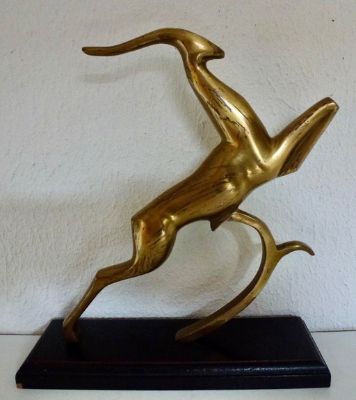 Beautiful brass gazelle on a lacquered wooden base.