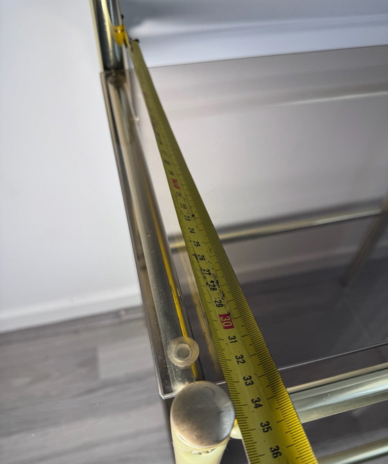 Vintage Regency stule  two-tier side table or nightstand featuring a brass-finished metal frame and smoked (photo 6 of 14)