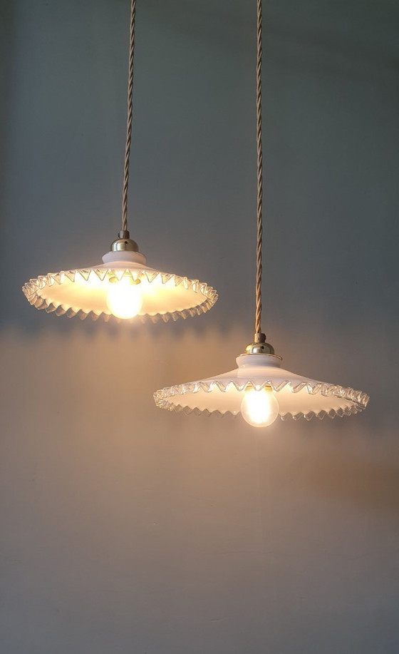 Image 1 of 2 vintage hanglampen van wit opaline glas met een transparante sierrand.