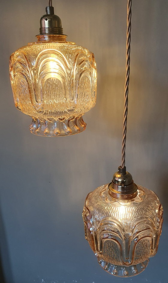 Image 1 of Set of 2 Vintage textured rose / amber tinted pendant lamps - mid-century design.