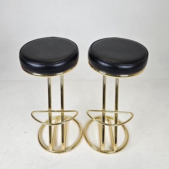 Image 1 of two bar stools, distinguished by their clean lines, high-quality craftsmanship, and timeless elegance.