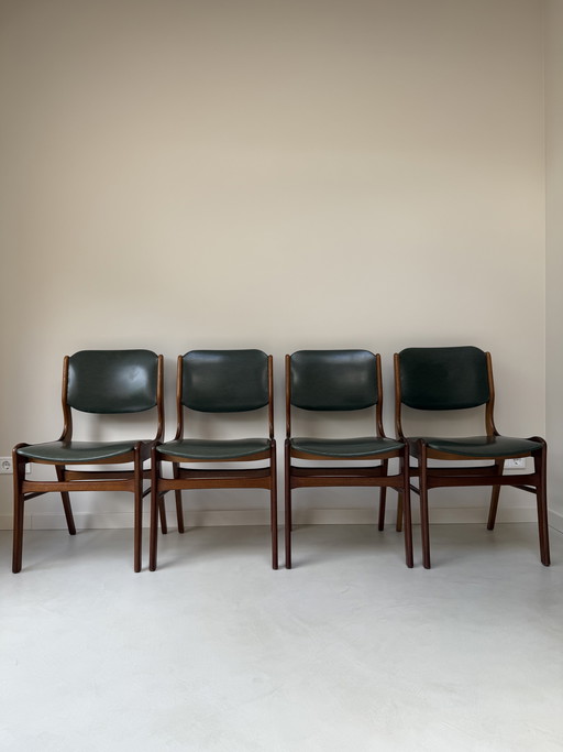 Four vintage wooden chairs with green faux leather
