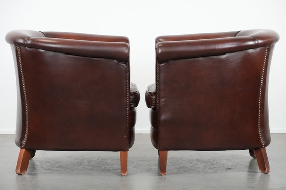 Image 1 of 2 poltrone club in pelle bovina in buone condizioni, di un lussuoso colore rosso/marrone.