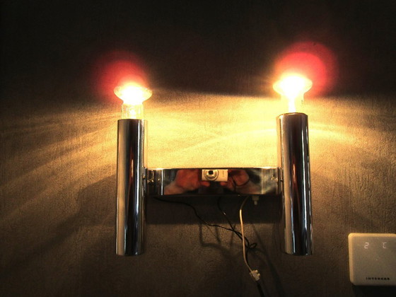 Image 1 of This chrome-colored space-age wall lamp is attributed to designer Gaetano Sciolari from the 1970s.