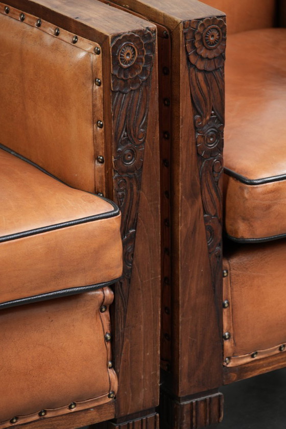 Image 1 of 2 x Prachtige schapenleren Art Deco fauteuil met mooi houtsnijwerk en zwarte biezen