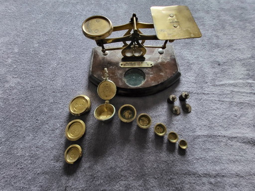 English letter scale with stack weights and a set of cup weights