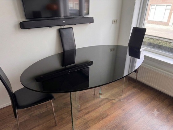 Image 1 of Oval smoked glass dining table
