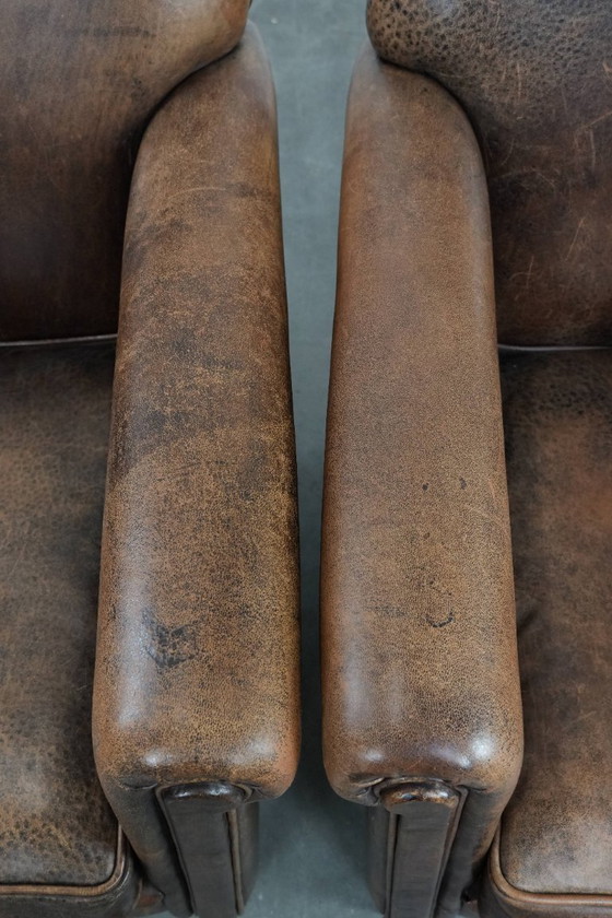 Image 1 of 2 x Vintage sheepskin armchair with warm colours and a characterful appearance