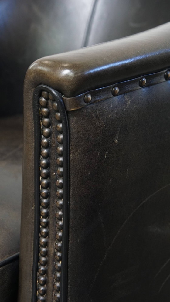 Image 1 of  Set van 2 subtiele zwart/ grijze schapenleren clubfauteuils 