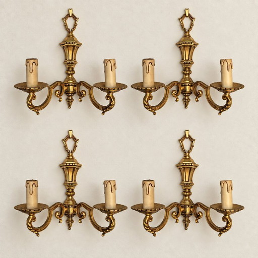 Suite of four two-light gilded brass wall lights — Louis XVI style
