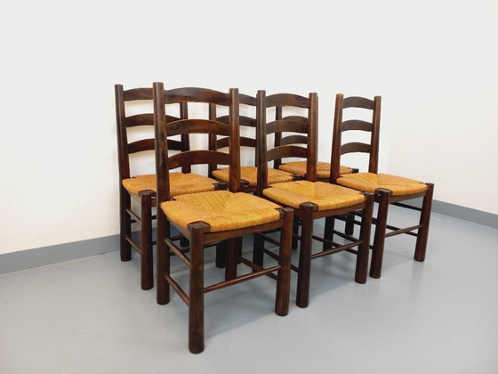 Image 1 of Set van 6 vintage brutalistische stoelen van Georges Robert, gemaakt van hout en stro, uit de jaren 50 en 60.