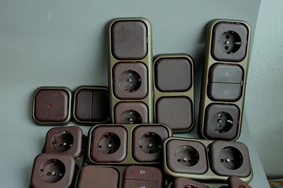 Image 1 of Large collection of vintage brown sockets and light switches with antique gold frames, 1960s/70s