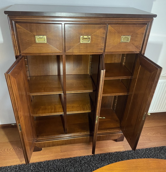 Image 1 of Mueble menaje de madera de cerezo con tres puertas y cajones.