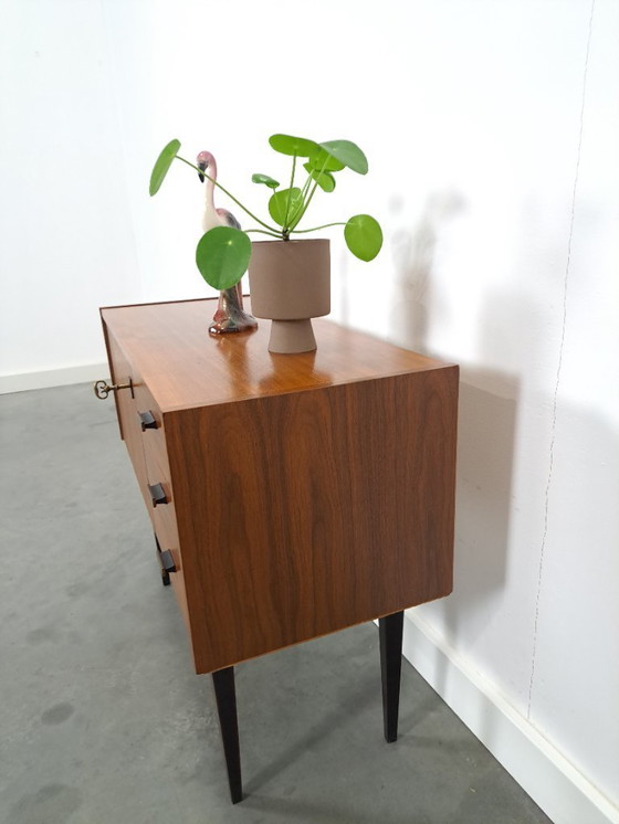 Image 1 of Mid-Century teak kastje op hoge zwarte poten met lades