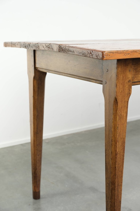 Image 1 of Large, relatively narrow antique French farmhouse dining table made of pine from the early 19th century with a beautiful patina.