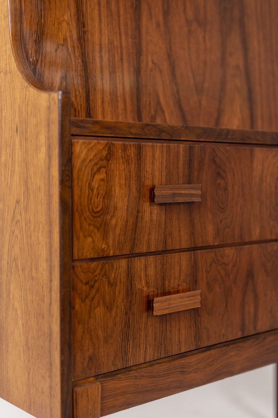 Image 1 of Commode van palissanderhout met 2 laden, die tevens als secretair dient. Jaren 70.