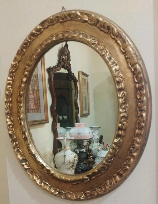 Specchio ovale con antica cornice in foglia oro stile Barocco 