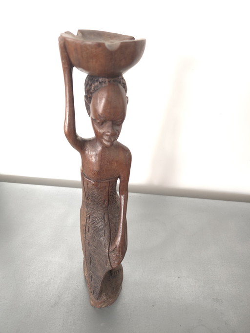 African statue of a woman with a bowl