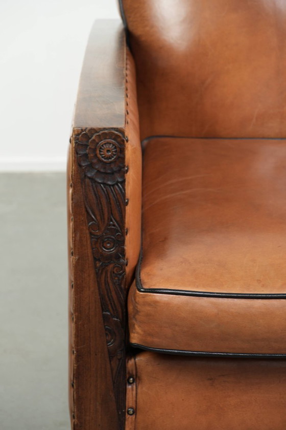 Image 1 of Unieke schapenleren art Deco fauteuil met mooi houtsnijwerk en zwarte biezen
