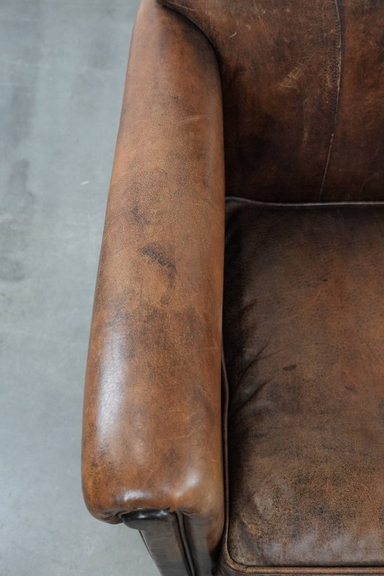 Image 1 of 2 x Vintage sheepskin armchair with warm colours and a characterful appearance