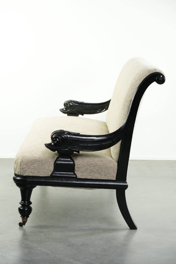 Luxurious 19th-century French sofa in Empire style with cream-colored fabric and uniquely detailed armrests. (photo 4 of 13)