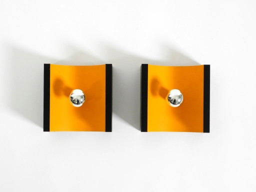 A rare pair of original 1960s Space Age metal wall lamps by Klaus Hempel for Kaiser Leuchten in yellow and black