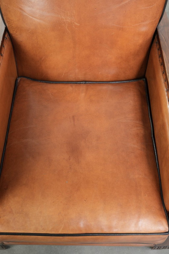 Image 1 of 2 x Prachtige schapenleren Art Deco fauteuil met mooi houtsnijwerk en zwarte biezen