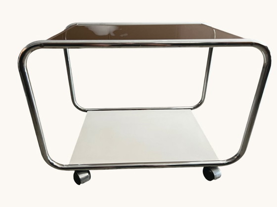 Image 1 of Vintage Space Age side table made of chrome and smoked glass. Sculptural 70s design with wheels.