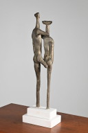 Tall sculpture on a marble pedestal